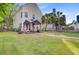 Beautiful backyard featuring a tent-like seating area, grass, and palm trees at 86 Cross Timbers Dr, Summerville, SC 29485