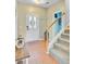 Bright foyer featuring tile flooring, staircase, and coat rack creating an organized space at 86 Cross Timbers Dr, Summerville, SC 29485