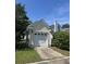 Detached one-car garage with white door and siding, nestled in a well-maintained yard with mature trees at 86 Cross Timbers Dr, Summerville, SC 29485