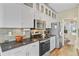 Modern kitchen with white cabinets, stainless steel appliances, and sleek countertops at 86 Cross Timbers Dr, Summerville, SC 29485