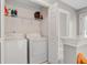 Convenient laundry room equipped with a washer, dryer, and shelving, providing ample storage space at 86 Cross Timbers Dr, Summerville, SC 29485