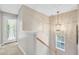Elegant staircase featuring a decorative chandelier and a window, enhancing the home's ambiance at 86 Cross Timbers Dr, Summerville, SC 29485