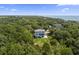 An attractive three-story house with a grassy backyard surrounded by dense trees, providing both privacy and beauty at 912 Cheehaw St, Edisto Island, SC 29438