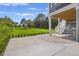 Large backyard with manicured lawn, a patio, and stairway leading up to the second floor deck at 912 Cheehaw St, Edisto Island, SC 29438