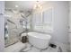 A luxurious bathroom with a modern tub, glass shower, and stylish marble flooring at 912 Cheehaw St, Edisto Island, SC 29438