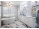 The bathroom features marble floors, a bathtub and double vanities at 912 Cheehaw St, Edisto Island, SC 29438