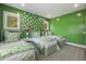 A vibrant green bedroom with three beds and playful bird wallpaper at 912 Cheehaw St, Edisto Island, SC 29438