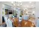 Dining area with an adjacent kitchen, stylish lighting, and space for entertaining at 912 Cheehaw St, Edisto Island, SC 29438
