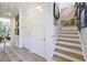 Hallway leading to staircase, natural light, and neutral colors at 912 Cheehaw St, Edisto Island, SC 29438