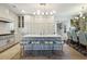 Spacious open kitchen featuring a large island with seating, stainless steel appliances and a dining area at 912 Cheehaw St, Edisto Island, SC 29438