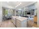 Bright, open kitchen with an island featuring an island with seating, extending into dining and living area at 912 Cheehaw St, Edisto Island, SC 29438