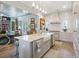 Bright, open kitchen featuring an island with seating, stainless steel appliances, and marble countertops at 912 Cheehaw St, Edisto Island, SC 29438
