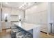 Bright, open kitchen featuring a large island with seating, stainless steel appliances, and custom cabinets at 912 Cheehaw St, Edisto Island, SC 29438