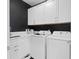 A clean laundry room features a white washer, dryer, and cabinets at 912 Cheehaw St, Edisto Island, SC 29438