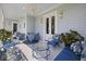 Light and airy porch featuring stylish blue furniture, a chandelier, and sun-drenched space for relaxing at 912 Cheehaw St, Edisto Island, SC 29438