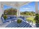 Covered porch featuring blue designer furniture with serene views, creating an inviting outdoor living space at 912 Cheehaw St, Edisto Island, SC 29438