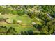 Scenic aerial view of a pristine golf course surrounded by lovely homes and mature trees at 1187 Out Of Bounds Dr, Summerville, SC 29485