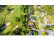 Aerial view of a neighborhood showcasing a lush golf course, tree-lined streets, and manicured lawns at 1187 Out Of Bounds Dr, Summerville, SC 29485