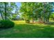 A spacious and well-maintained backyard is complemented by mature trees and manicured lawn at 1187 Out Of Bounds Dr, Summerville, SC 29485