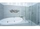 The bathroom features a luxurious soaking tub and a frameless glass shower at 1187 Out Of Bounds Dr, Summerville, SC 29485