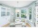 Cozy breakfast nook with glass table, white chairs, and bright windows at 1187 Out Of Bounds Dr, Summerville, SC 29485