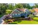 Charming brick home with blue shutters, inviting front porch, and lush landscaping, surrounded by mature trees at 1187 Out Of Bounds Dr, Summerville, SC 29485