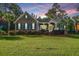 Charming home featuring a brick facade and vibrant landscaping, accentuated by a colorful sunset at 1187 Out Of Bounds Dr, Summerville, SC 29485
