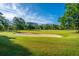 Scenic view of the golf course with manicured greens, mature trees, and a clear blue sky at 1187 Out Of Bounds Dr, Summerville, SC 29485