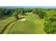 Expansive view of lush green golf course, featuring mature trees, a sand trap, and a meandering stream at 1187 Out Of Bounds Dr, Summerville, SC 29485