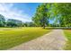 Scenic golf course view showcasing a smooth cart path winding through grassy terrain and mature trees at 1187 Out Of Bounds Dr, Summerville, SC 29485