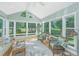 Bright sunroom features vaulted ceilings, large windows, and comfortable seating, perfect for enjoying the natural light at 1187 Out Of Bounds Dr, Summerville, SC 29485