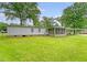 Expansive backyard featuring a screened-in porch, carport, and lush green lawn, ideal for outdoor enjoyment at 1210 Azalea Dr, Summerville, SC 29483