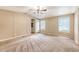 Bright bedroom with large windows, carpet flooring, and a ceiling fan fixture at 1210 Azalea Dr, Summerville, SC 29483