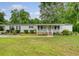Charming single-story home with landscaped front yard, inviting entrance, and driveway with mature trees at 1210 Azalea Dr, Summerville, SC 29483