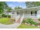 Inviting front porch with brick stairs and white railings and a well maintained front yard at 1210 Azalea Dr, Summerville, SC 29483