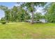 Spacious front yard showcasing a well-maintained lawn, a charming home, and a patriotic American flag at 1210 Azalea Dr, Summerville, SC 29483