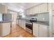 Well-lit kitchen featuring stainless steel appliances, modern countertops, and a kitchen window at 1210 Azalea Dr, Summerville, SC 29483