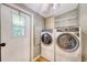 Functional laundry room with modern washer and dryer, storage space, and exterior access at 1210 Azalea Dr, Summerville, SC 29483
