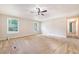 Bright living room with carpet, neutral walls, ceiling fan, and windows allowing natural light at 1210 Azalea Dr, Summerville, SC 29483