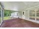 Covered porch with screen and concrete floor, offering a view of the lawn at 1210 Azalea Dr, Summerville, SC 29483