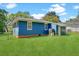 Rear exterior view of a blue one-story home with a large, grassy backyard at 1222 Maxwell St, North Charleston, SC 29405