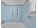 Bright bathroom features blue tile, grab bars, and a shower-tub combo at 1222 Maxwell St, North Charleston, SC 29405