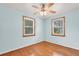 Bedroom with wood floors has a ceiling fan and two windows overlooking the yard at 1222 Maxwell St, North Charleston, SC 29405