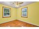 Bedroom with hardwood floors, two windows and a ceiling fan at 1222 Maxwell St, North Charleston, SC 29405