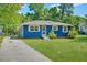 Charming blue home with a well-manicured front yard and driveway at 1222 Maxwell St, North Charleston, SC 29405