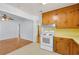 Open kitchen with wood cabinets, white appliances, and easy access to other rooms at 1222 Maxwell St, North Charleston, SC 29405