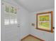 Bright mud room features access to the backyard, a window, and laundry hookups at 1222 Maxwell St, North Charleston, SC 29405