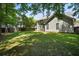 Large, grassy backyard with mature trees, providing shade and privacy at 1223 Creek Stone Way, Hanahan, SC 29410