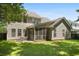 Exterior shot of a home's screened porch, patio, and spacious backyard at 1223 Creek Stone Way, Hanahan, SC 29410