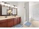 Well-lit bathroom features double sinks, vanity, decorative mirrors, and walk-in shower at 1223 Creek Stone Way, Hanahan, SC 29410